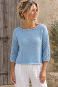 Billie Crop Top in Forget-me-not on a model with rustic backdrop